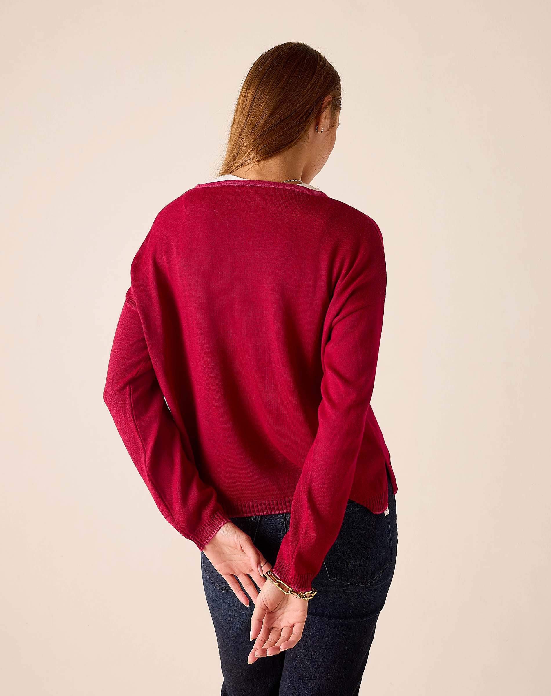 Back view of the wine color knit cardigan with ribbed trim and long sleeves.