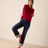 Wine colored knit sweater with a textured finish and long sleeves.