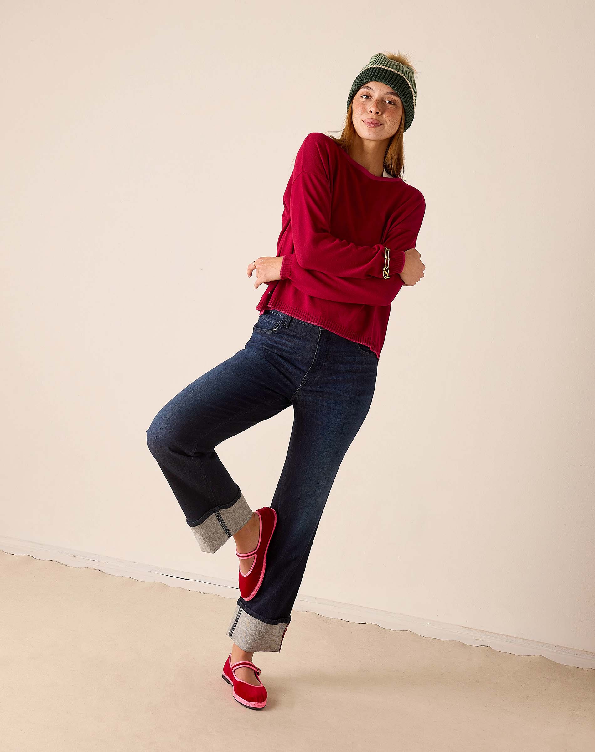 Wine colored knit sweater with a textured finish and long sleeves.