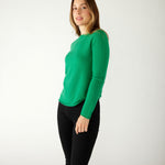 profile of woman wearing mersea carmel sweater in jade