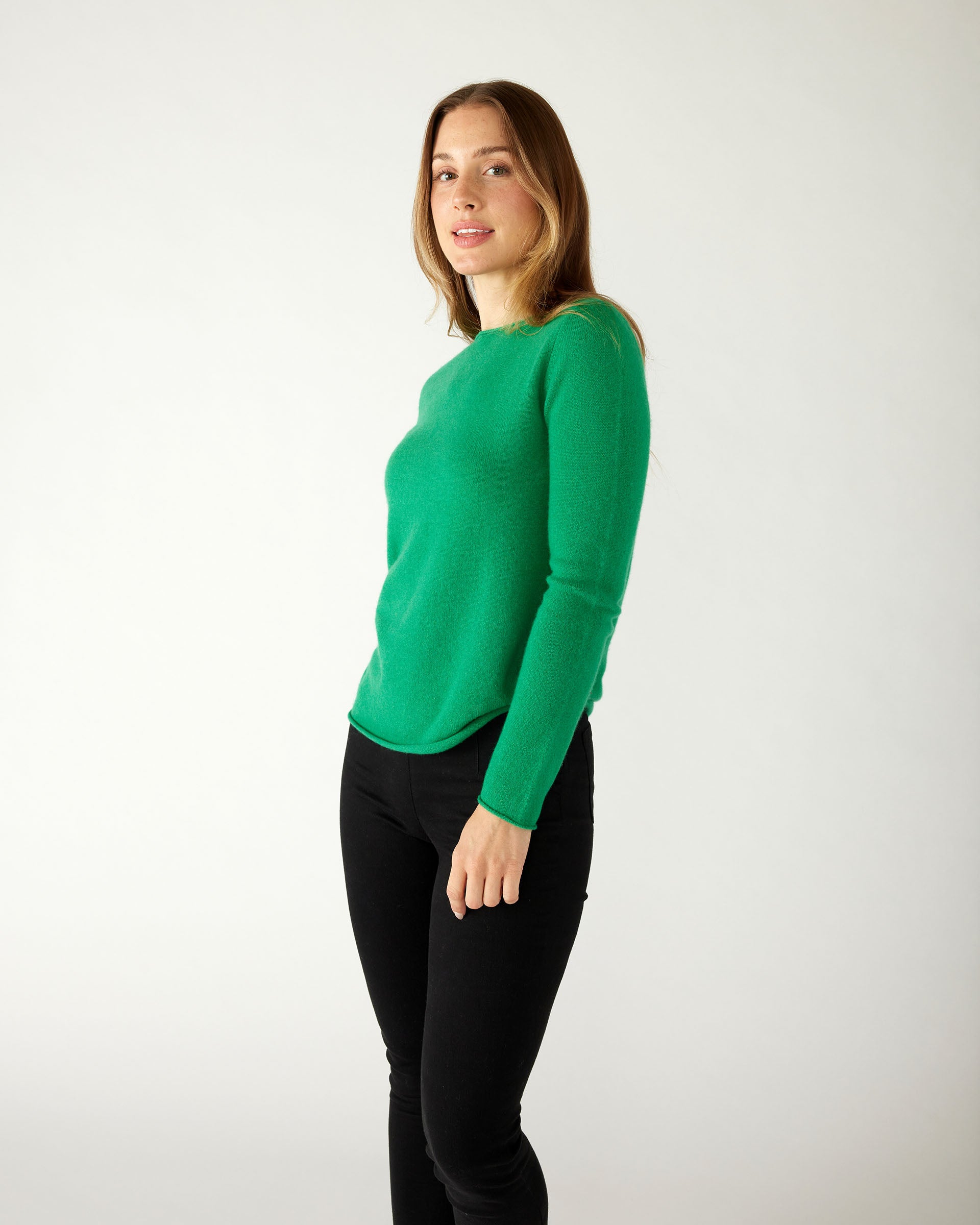 profile of woman wearing mersea carmel sweater in jade