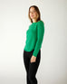 profile of woman wearing mersea carmel sweater in jade