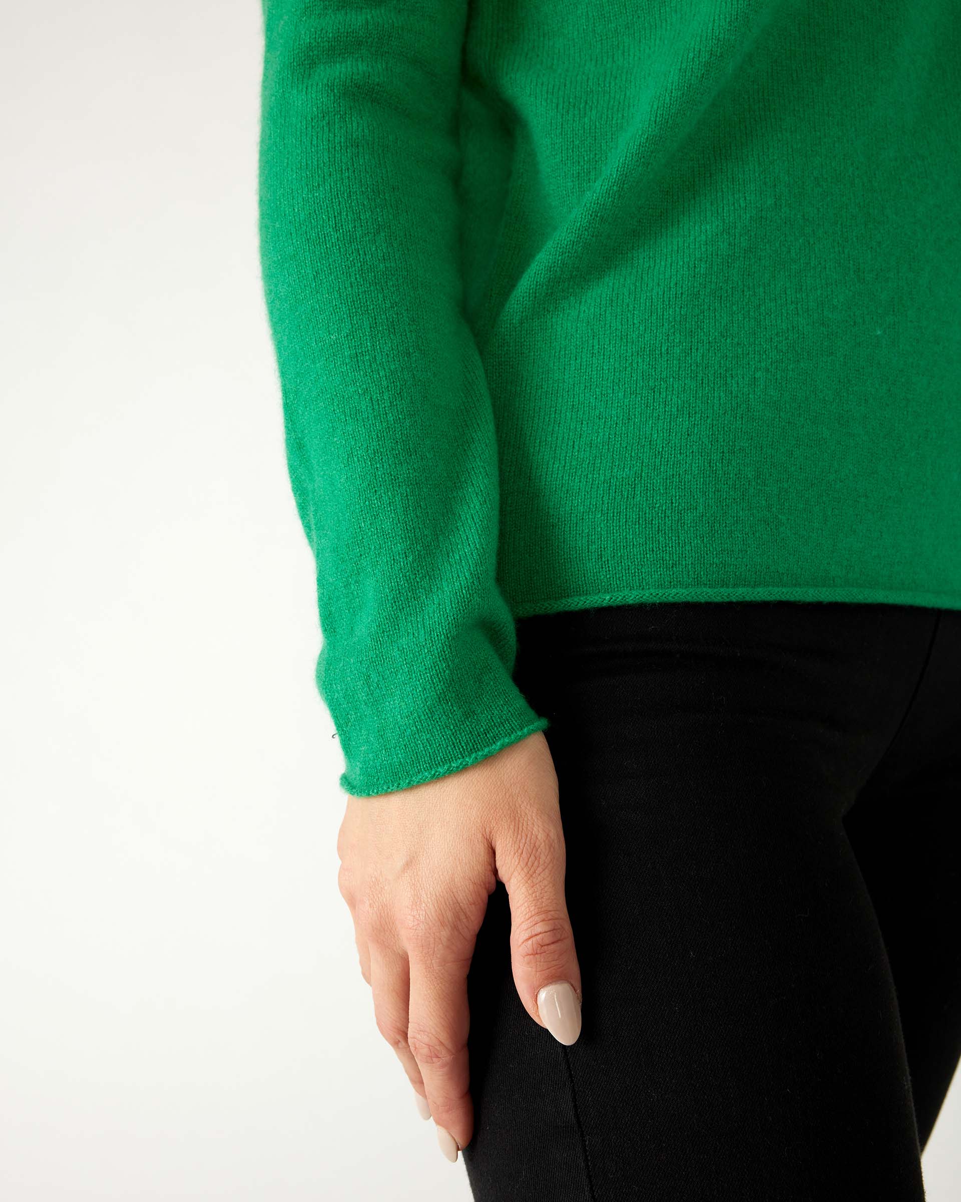 closeup of sleeve on woman wearing mersea carmel sweater in jade