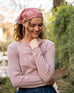 woman wearing mersea carmel pink rose sweater