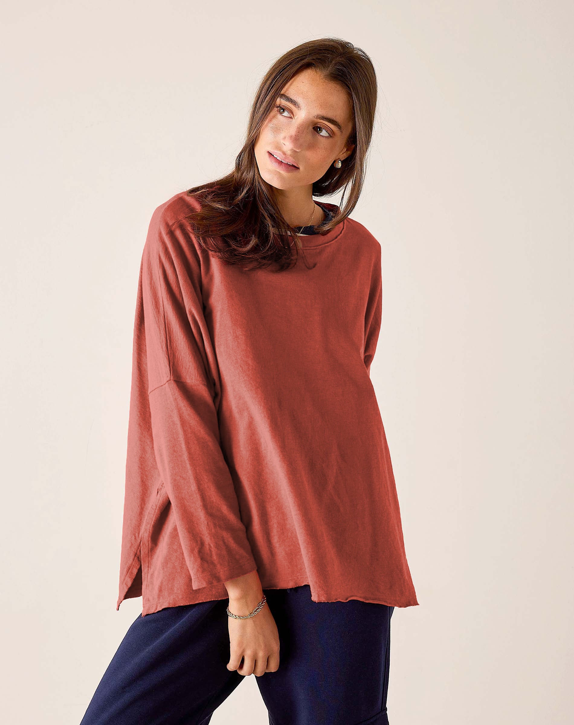 Terracotta-toned knit tee with wide sleeves and a relaxed fit.