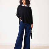 Ladies' travel-ready black oversized knit cashmere sweater with a ruffled collar detail