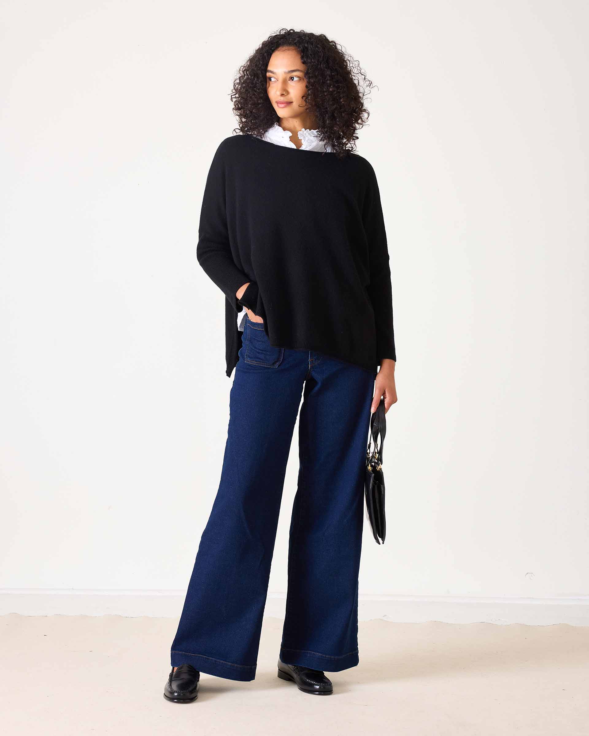Ladies' travel-ready black oversized knit cashmere sweater with a ruffled collar detail