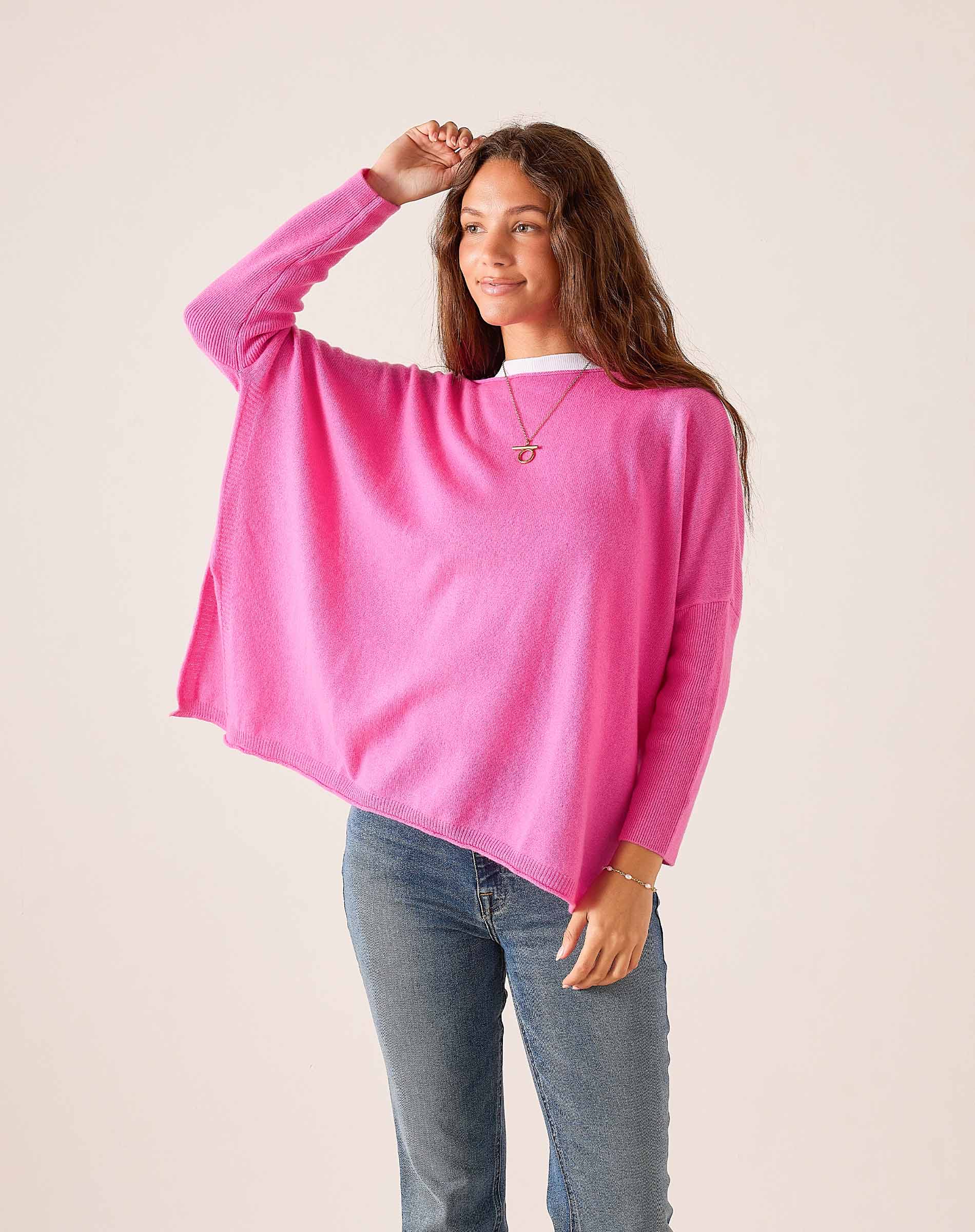 Sugar pink oversized cashmere knit sweater with relaxed fit and long sleeves.