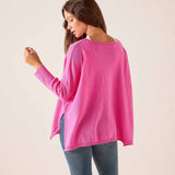 Sugar pink oversized cashmere sweater with a wide neckline and side slits.