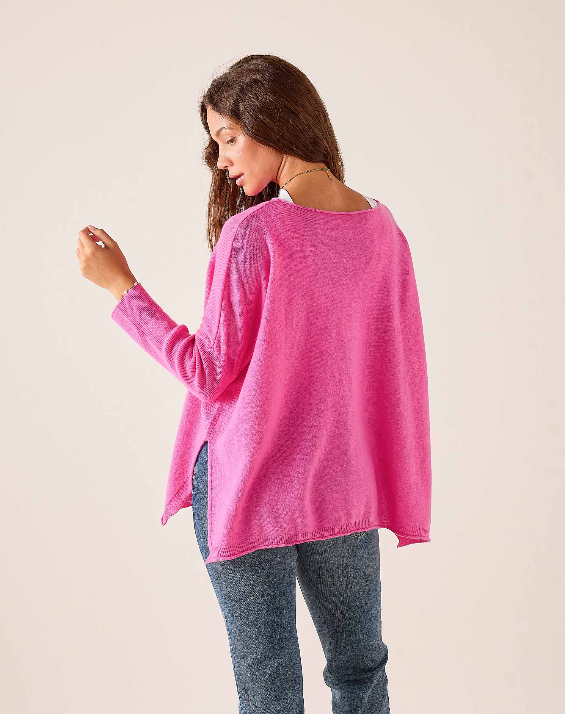 Sugar pink oversized cashmere sweater with a wide neckline and side slits.
