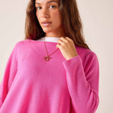 Sugar pink oversized cashmere knit sweater with a wide boat neck.