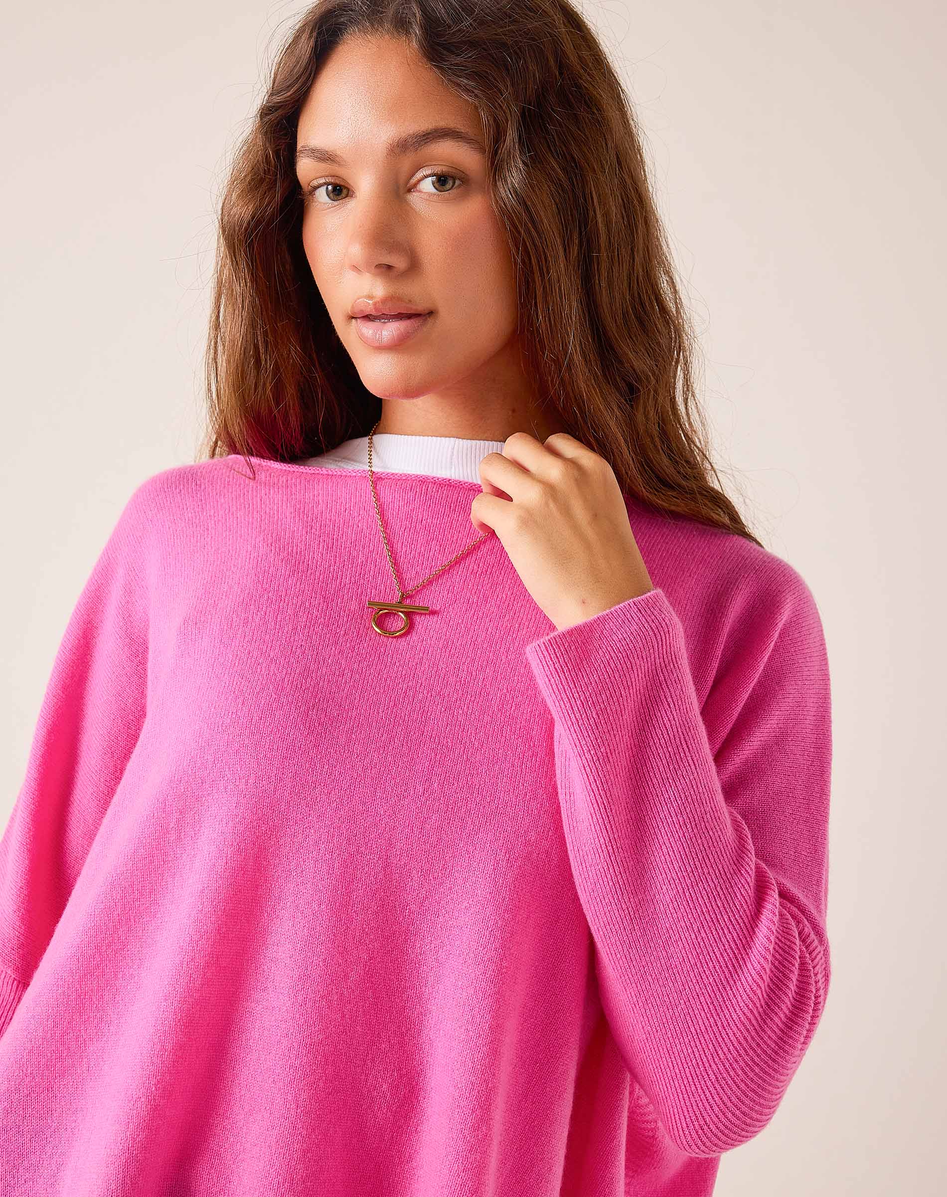 Sugar pink oversized cashmere knit sweater with a wide boat neck.