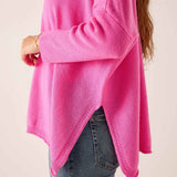 Sugar pink oversized knit sweater with ribbed detailing and side slits.
