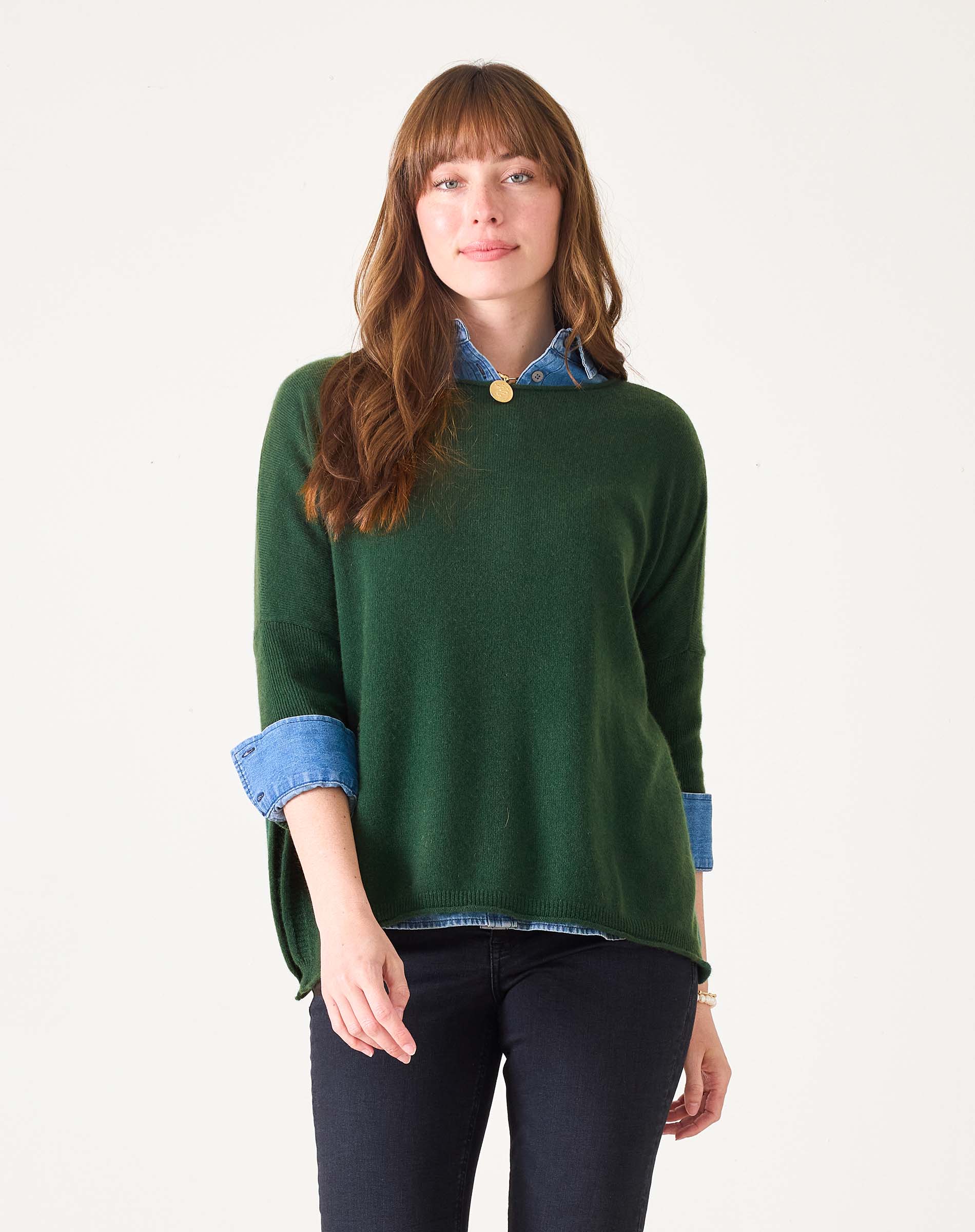 Women's travel-friendly hunter green cashmere knit sweater with a layered denim shirt collar and cuffs.