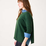 Hunter green cashmere sweater with a layered denim shirt collar and cuffs.