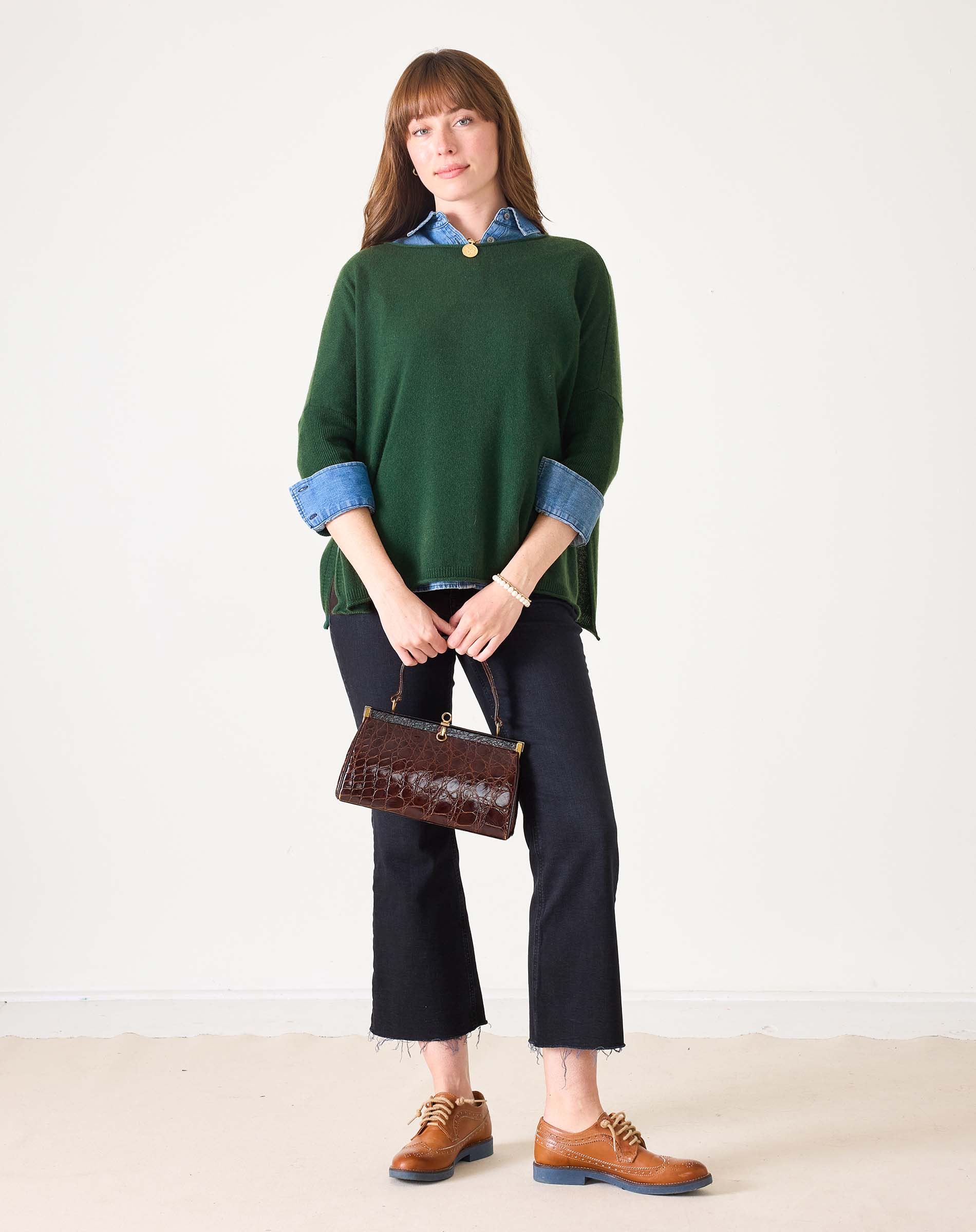 Hunter green cashmere knit sweater with a round neckline and dropped shoulders.