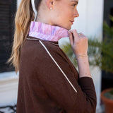 Side view of coffee and cream knit crewneck top with a white stripe and ruffled lavender collar.