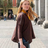 Coffee and cream contrast crewneck knit top with a relaxed fit, paired with denim jeans.
