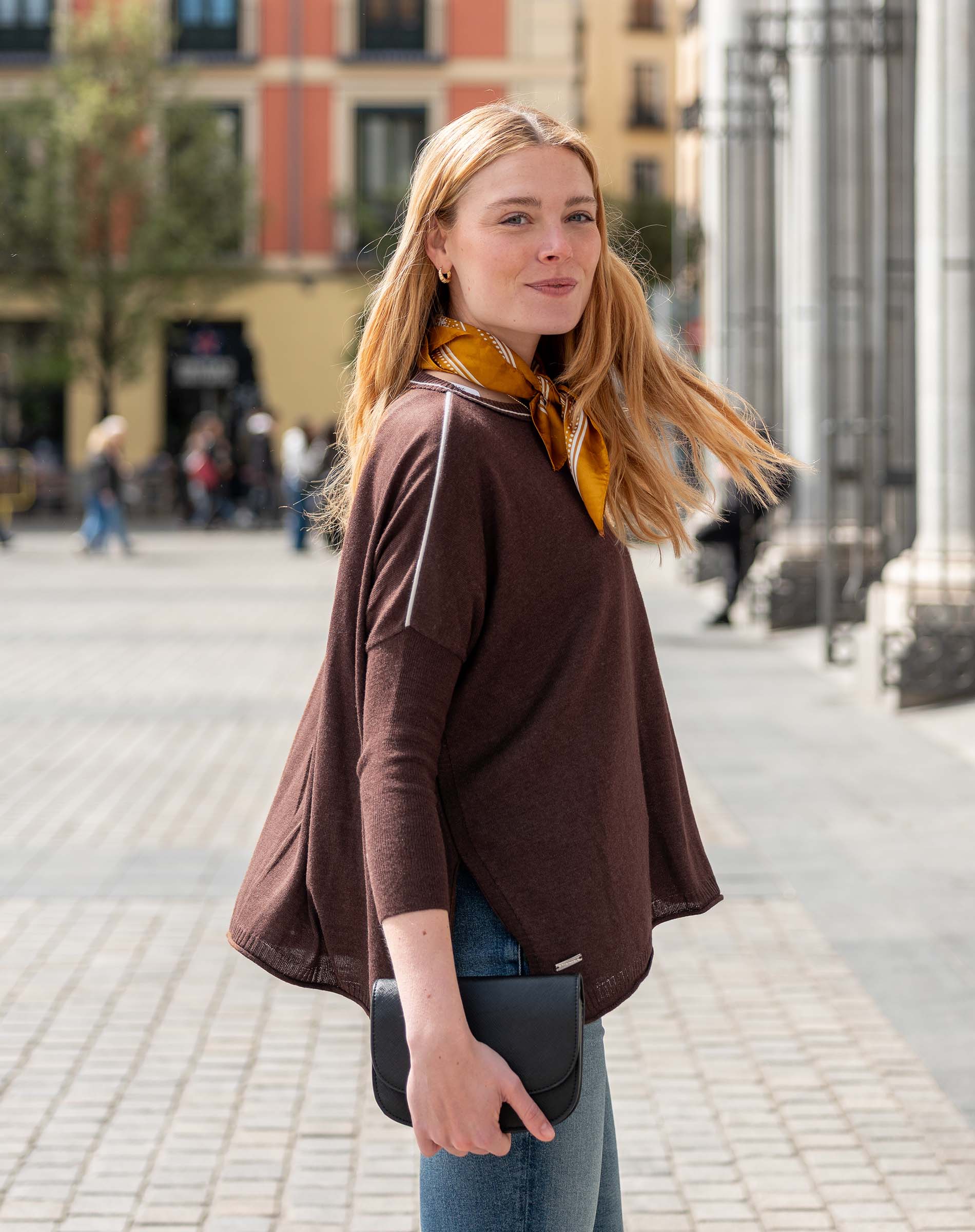 Coffee and cream contrast crewneck knit top with a relaxed fit, paired with denim jeans.