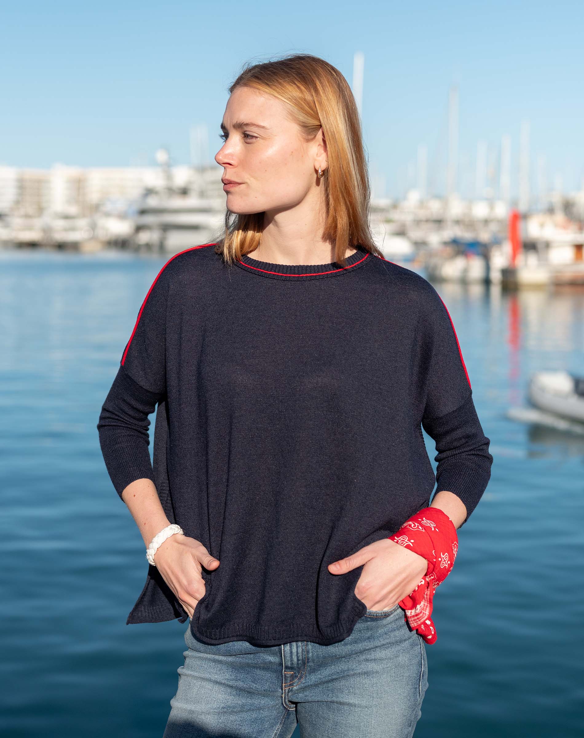 MERSEA women's travel-friendly navy knit top with red contrast trim on sleeves and neckline.