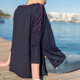 Navy blue knit top with red piping and long sleeves.