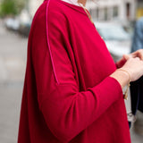 Wine pinkberry knit top with a contrasting crewneck line and long sleeves.