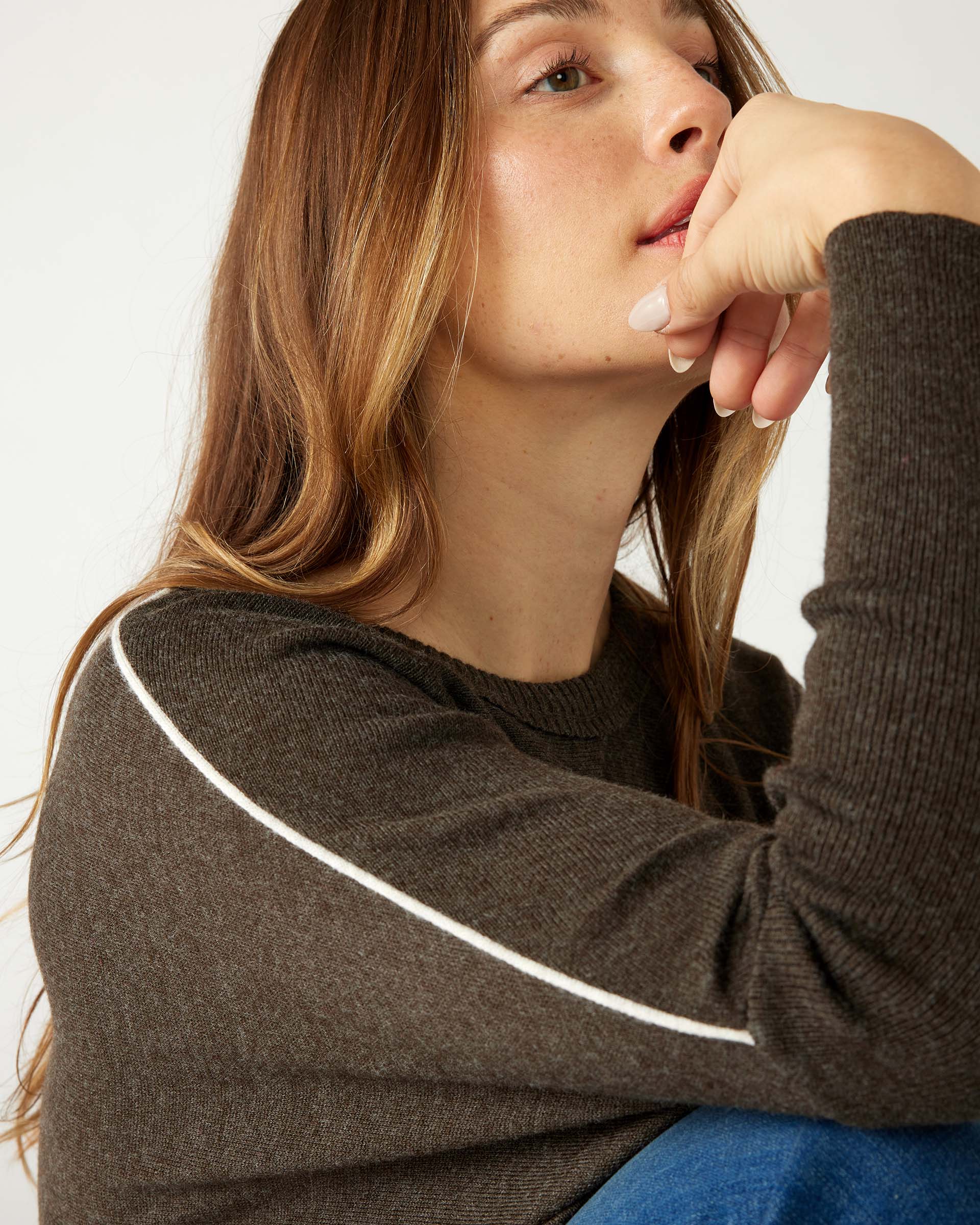 closeup of shoulder woman wearing mersea catalina contrast sweater in cocoa with white trim