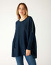 woman wearing mersea catalina contrast sweater in navy with chartuese trim
