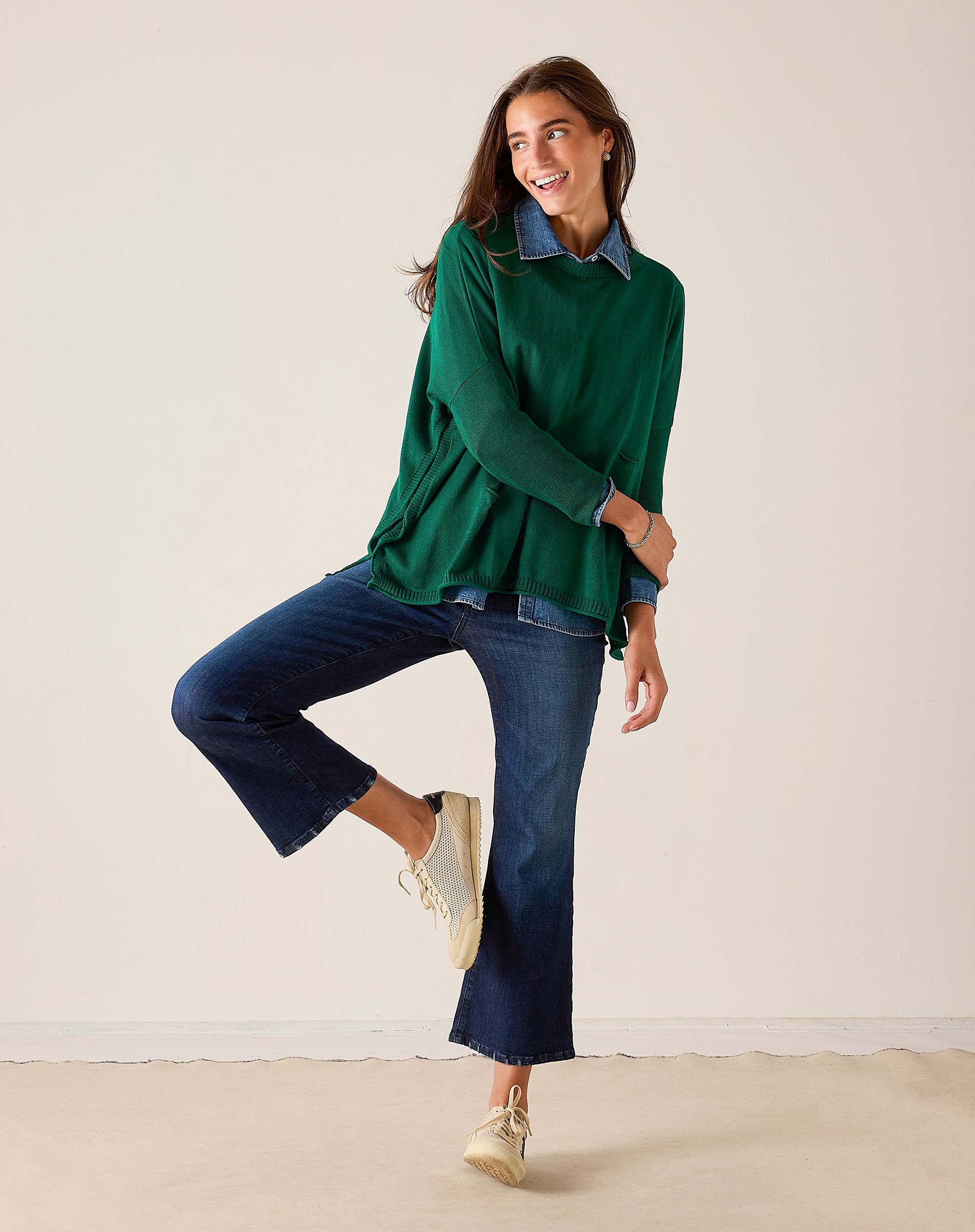 MERSEA ladies' travel-ready parakeet green cotton crewneck knit top paired with denim pants and sneakers.
