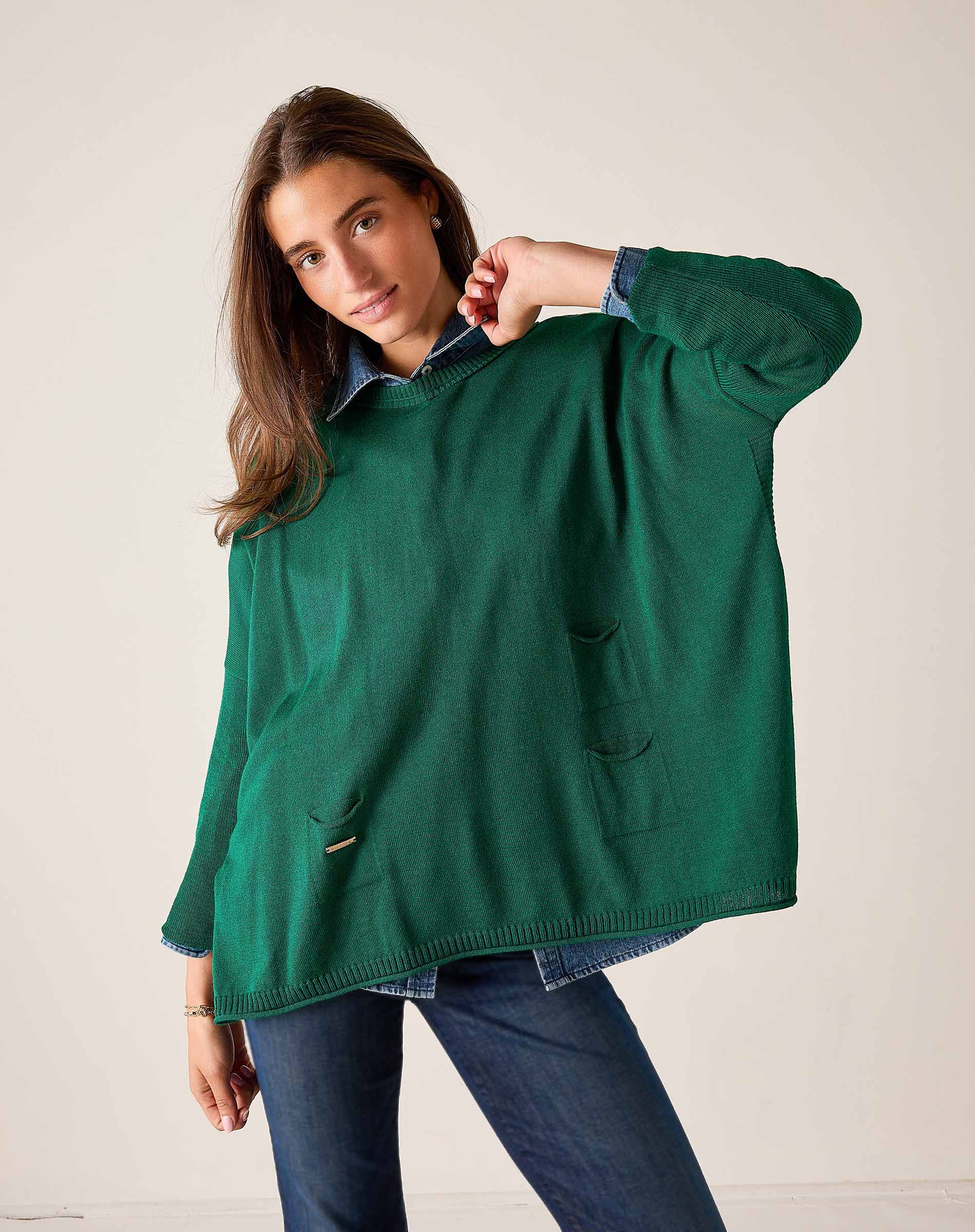 Parakeet green cotton crewneck knit top with front pockets worn over a button-down shirt.