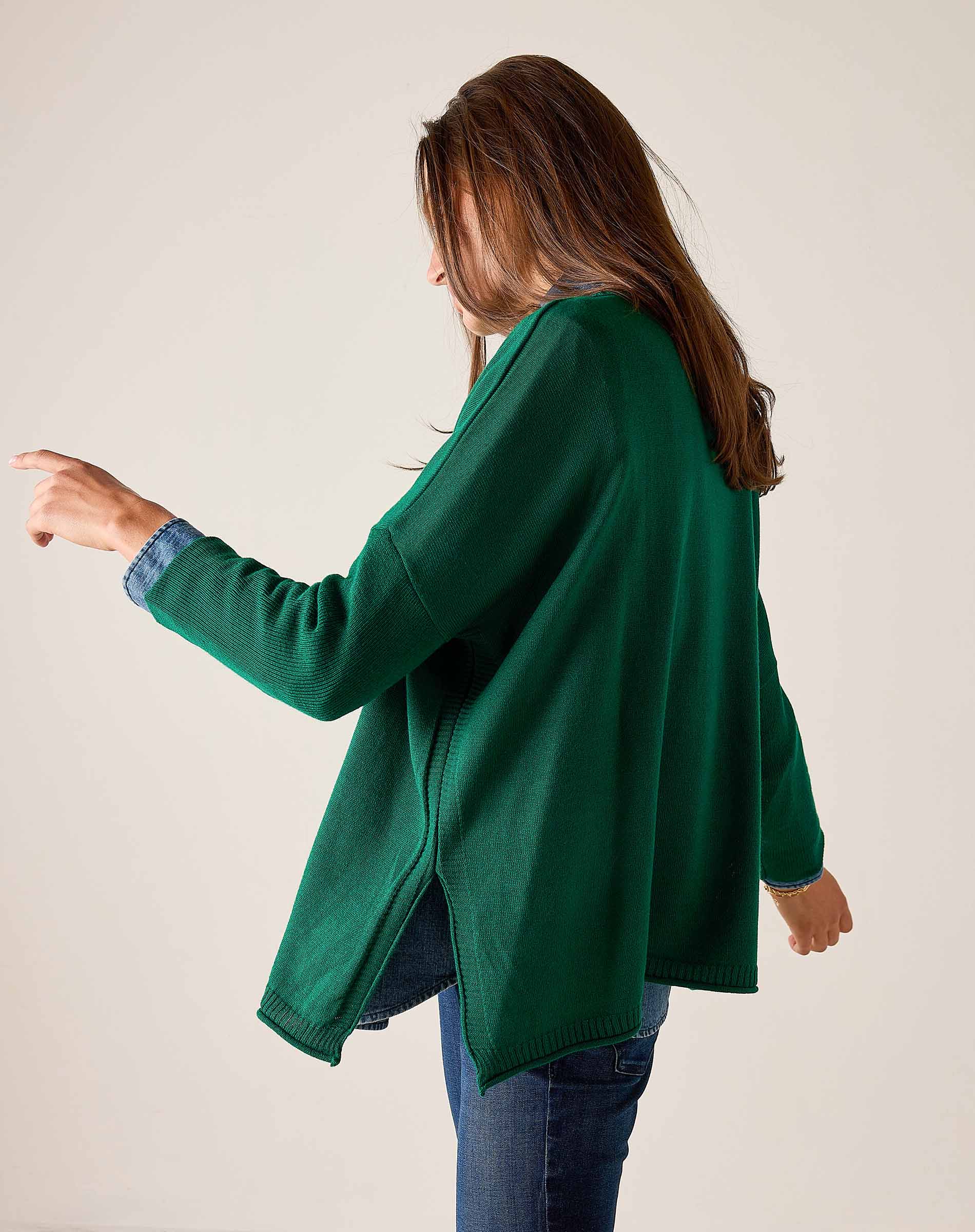 Side view of the parakeet green cotton crewneck knit top over blue jeans.