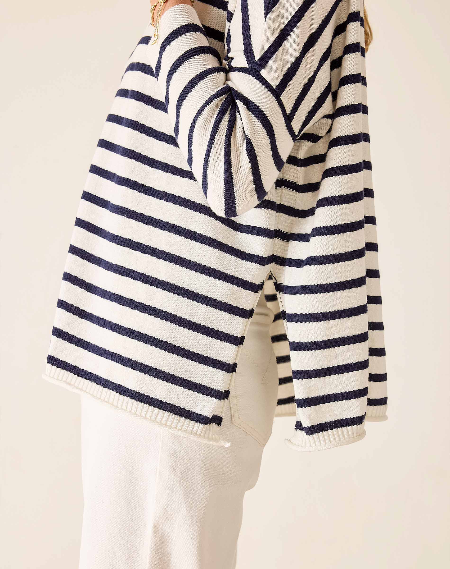 Navy and white striped sweater on a light background