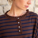 Walnut and marine striped cotton ruffle henley with a ruffled neckline and button placket.