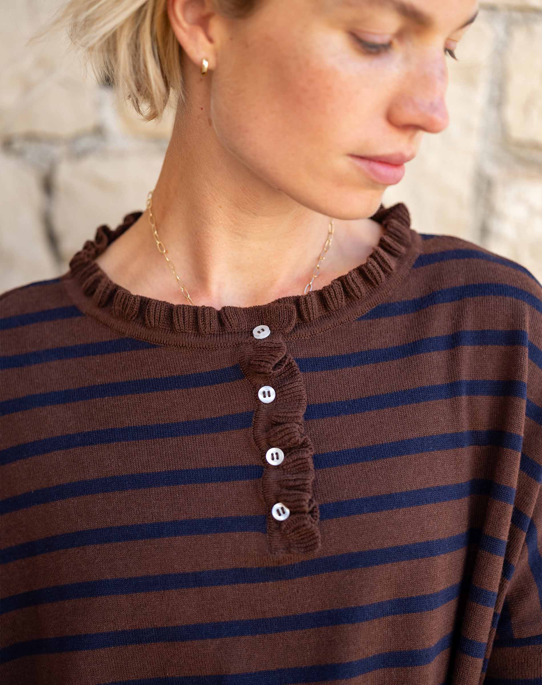 Walnut and marine striped cotton ruffle henley with a ruffled neckline and button placket.