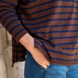 Walnut and marine striped knit Henley top with a ruffle detail.