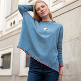 Aegan blue cotton ruffle sweater with vermillion trim.