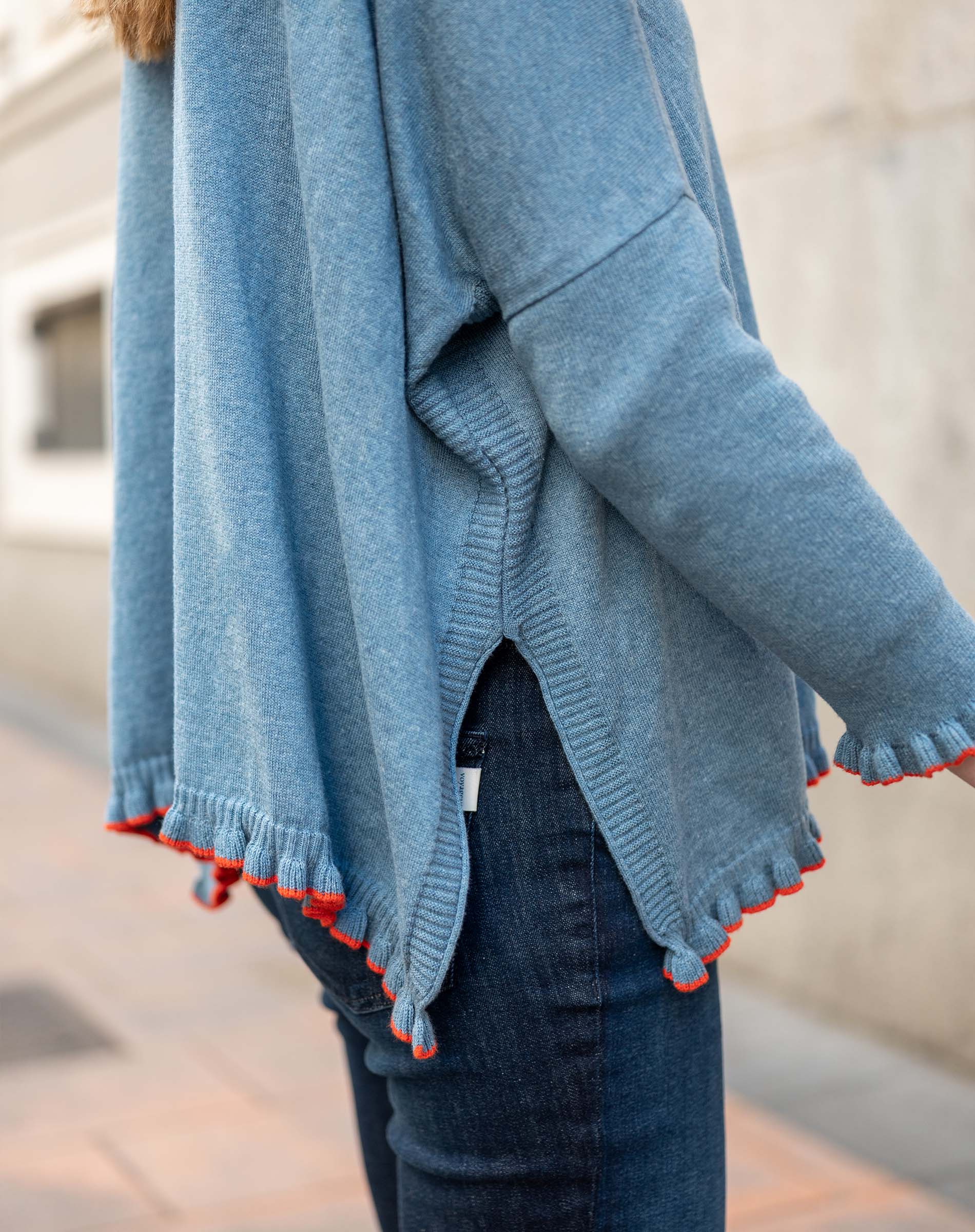 Aegan blue ruffled cotton sweater with vermillion accents on the hem and cuffs.