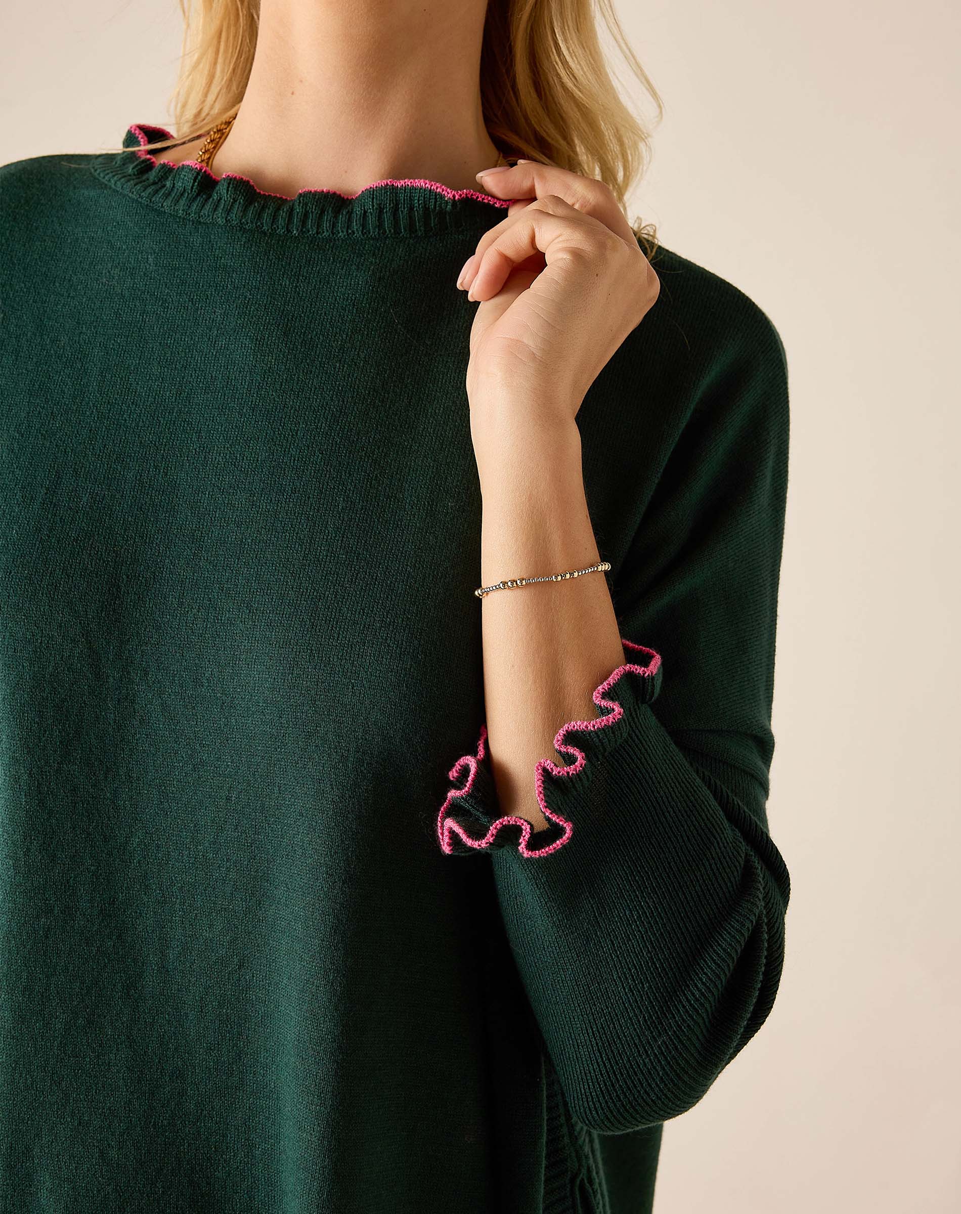 Forest green knit sweater with bubblegum pink ruffled trim.
