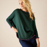 Forest green knit sweater with ruffled edges and bubblegum pink trim.