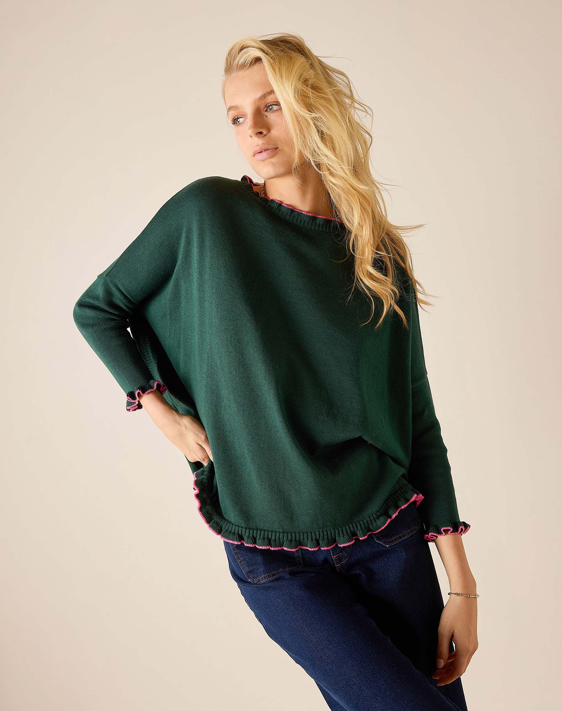 Forest green knit sweater with ruffled edges and bubblegum pink trim.