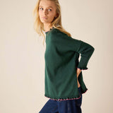 Forest green cotton knit sweater with ruffled trim and bubblegum pink accents.