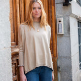 MERSEA ladies' travel-ready natural beige ruffled hem sweater in a relaxed fit with long sleeves.