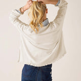 Back view of the warm white cotton ruffle sweater.