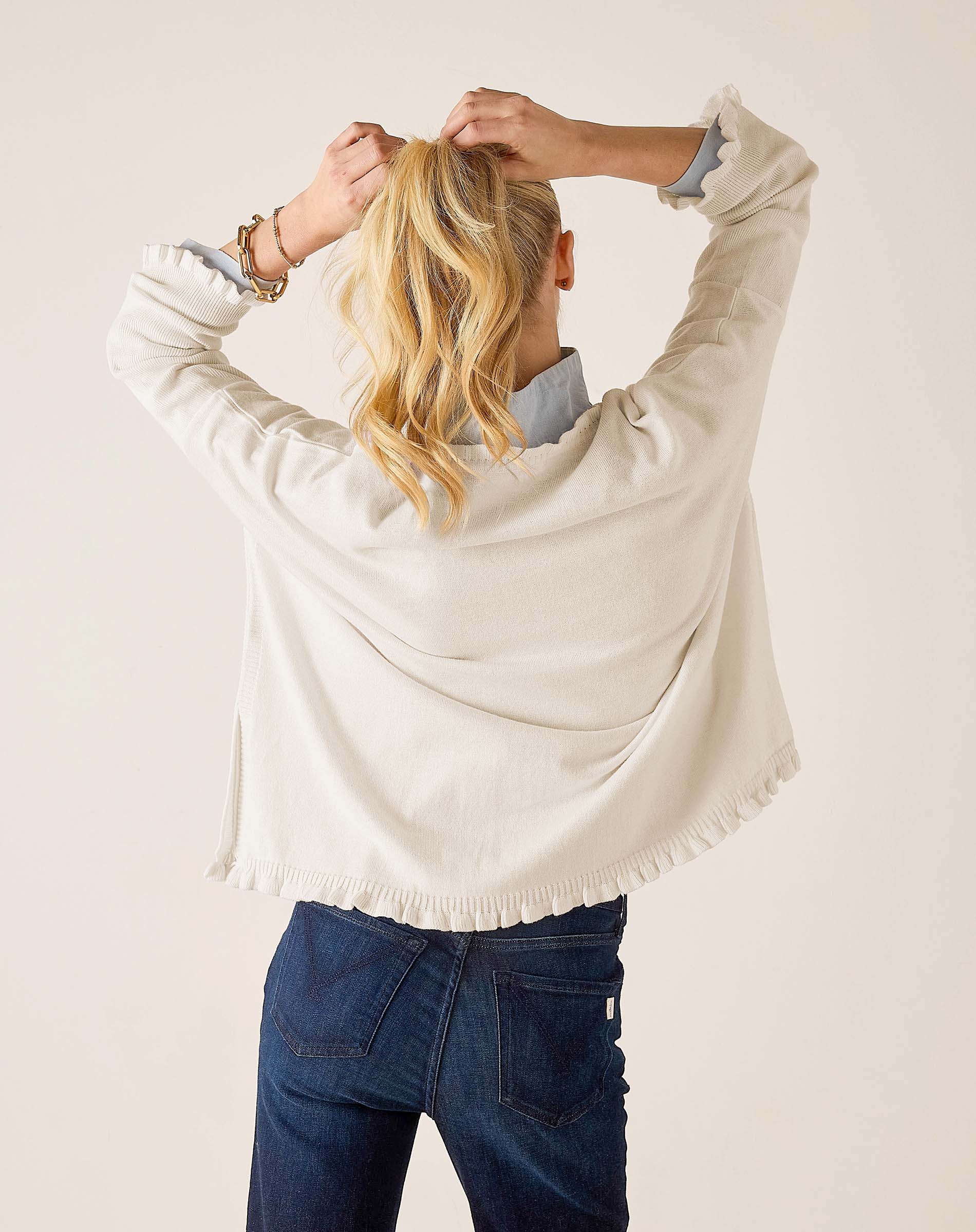 Back view of the warm white cotton ruffle sweater.
