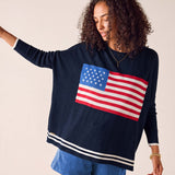 MERSEA women's travel-friendly navy blue crewneck knit top with an American flag graphic and striped hem.