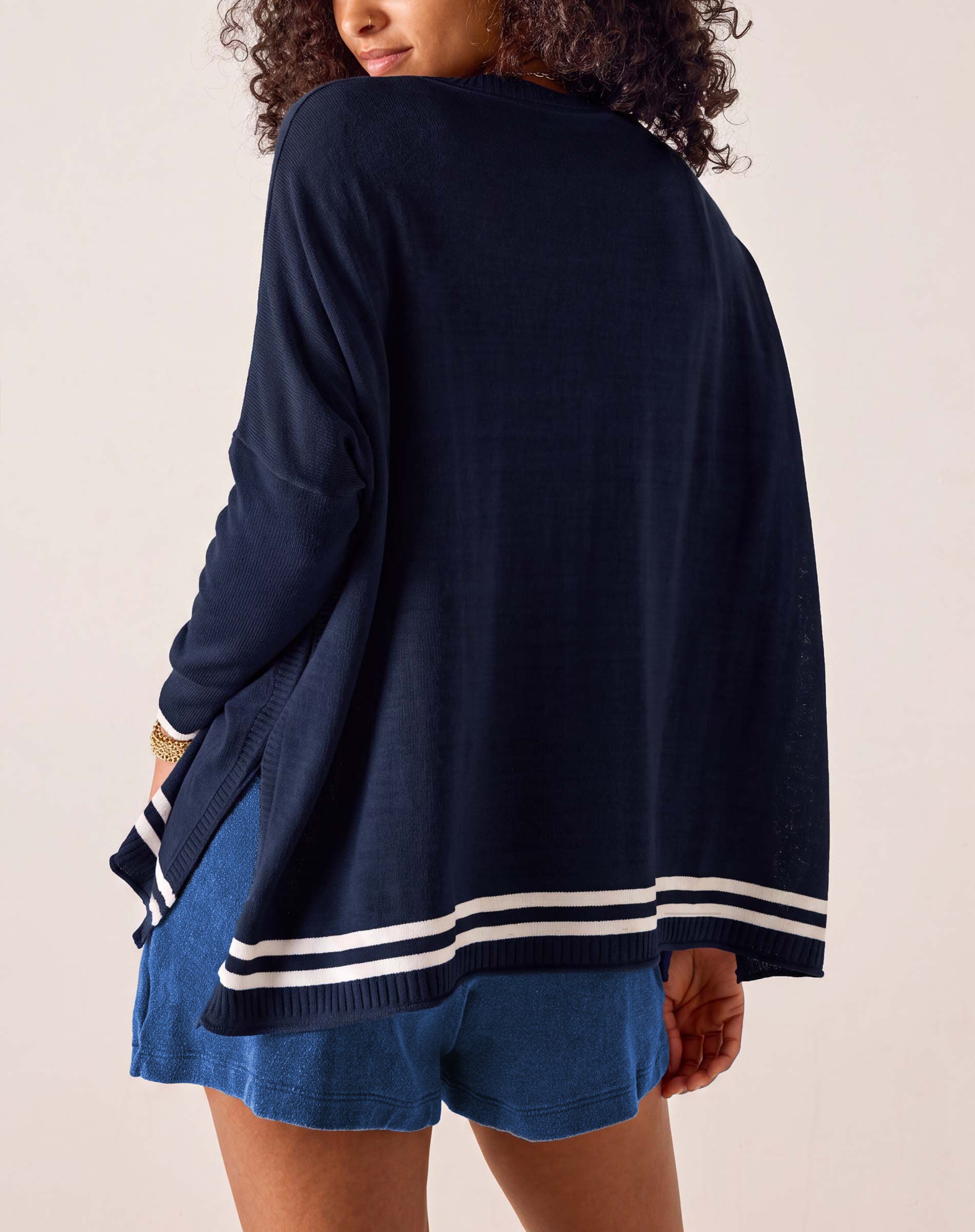 MERSEA ladies' travel-ready back view of the navy blue knit crewneck top with white stripes on the hem.