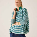Model wearing the Catalina crewneck knit top in deep ocean rain stripes with navy jeans.