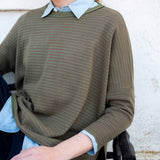 Olive green jungle stripe knit crewneck top with horizontal stripes.
