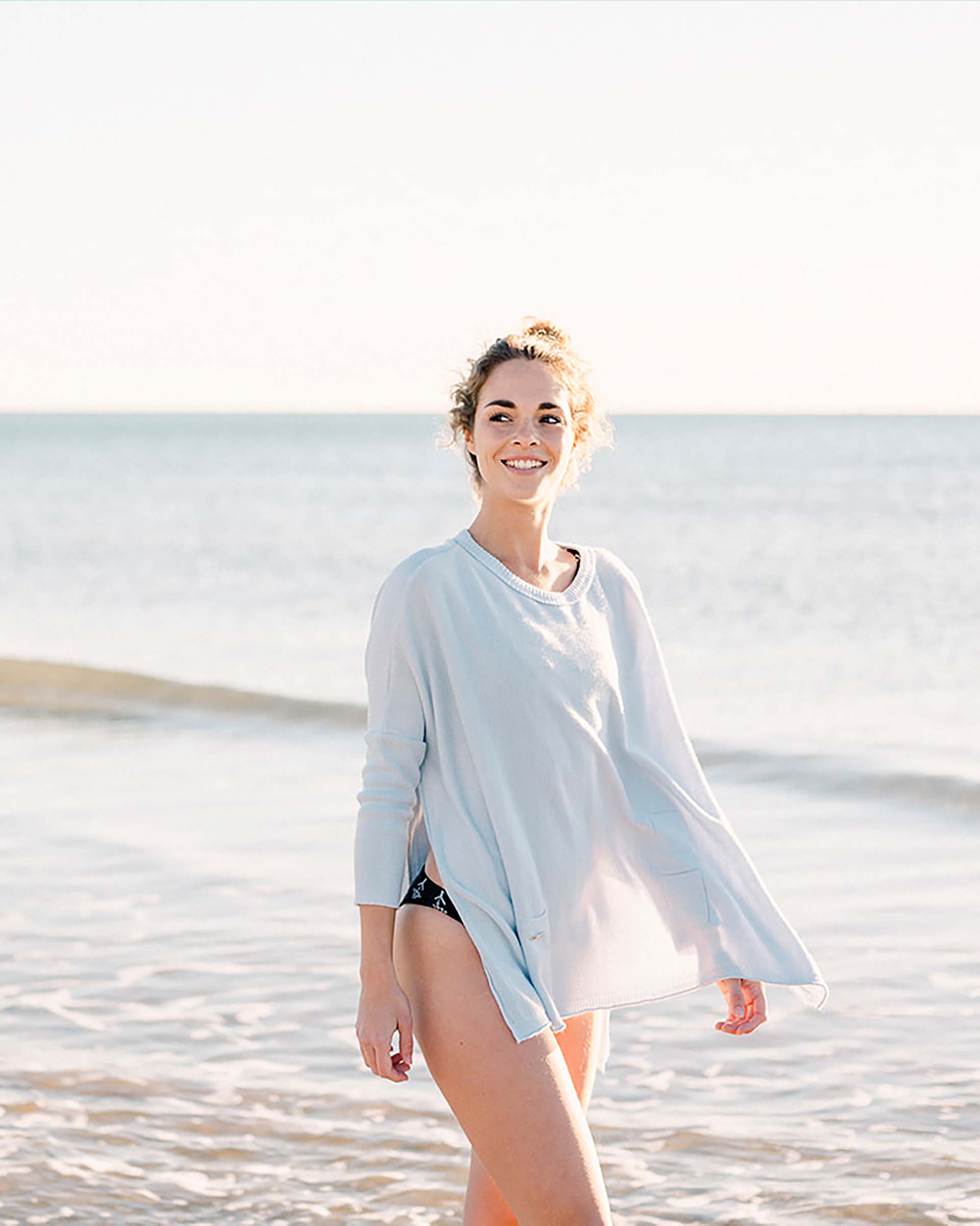 Woman wearing a light blue cover-up on a beach