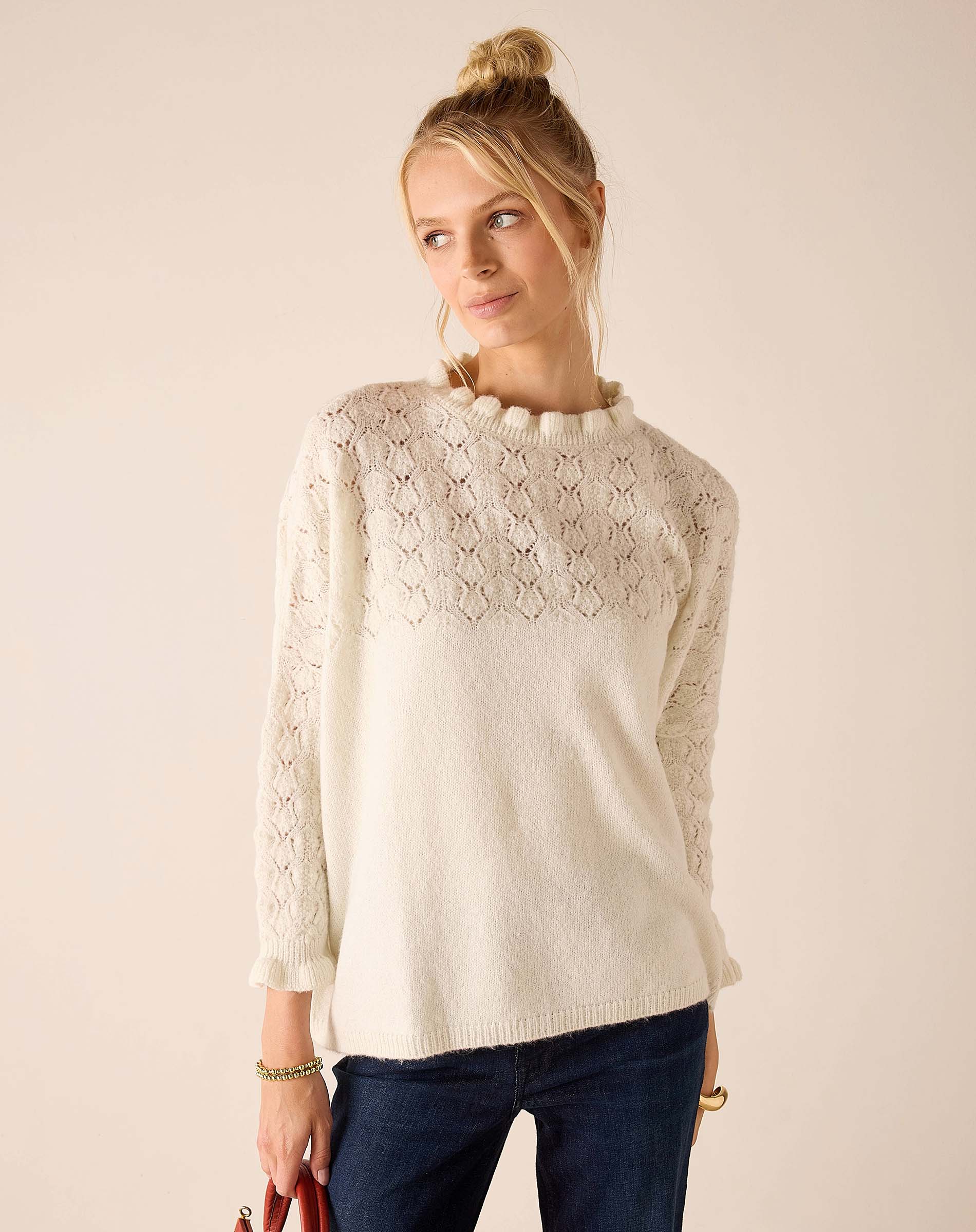 Cream cable-knit sweater with openwork lace detailing and a relaxed fit.
